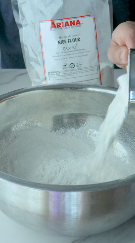 Add rice flour, powdered sugar, baking powder, baking soda and ground cardamom and mix together. 